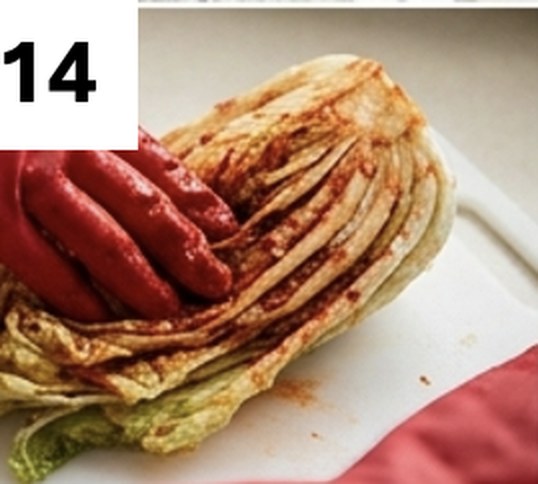 Step 14: spreading the marinade between the leaves of a cabbage quarter